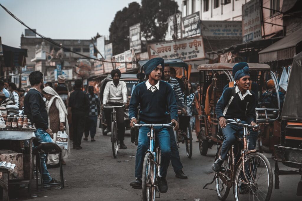 Street life in Amritsar with boys on bicycles and vibrant market activity.